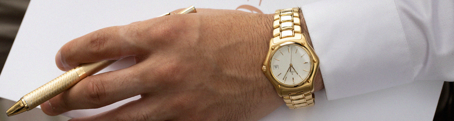 Man Wearing a Gold Wrist Watch