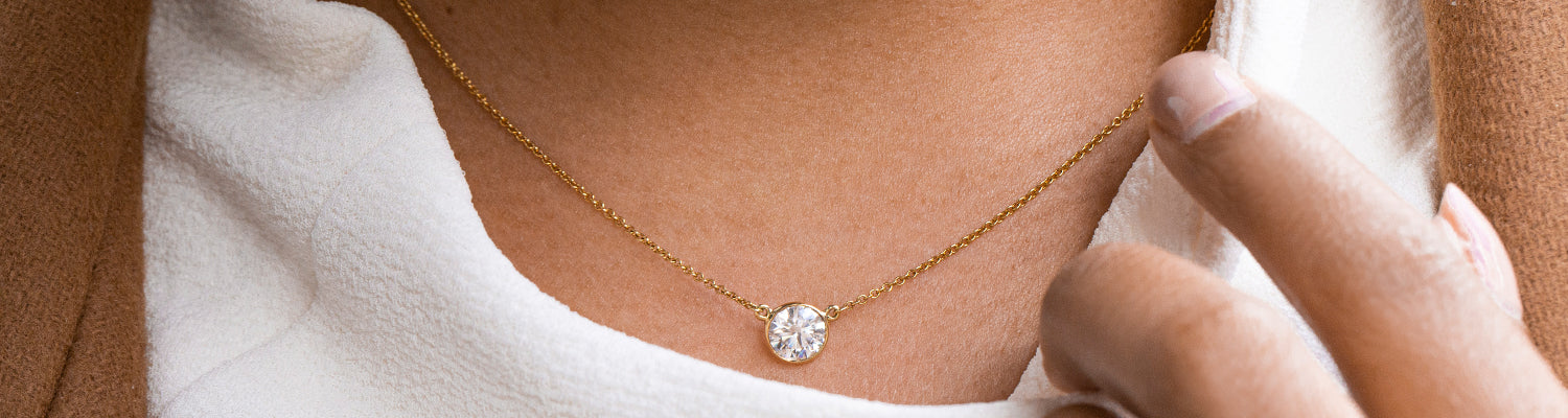 Woman Wearing a Diamond on a Gold Chain Necklace