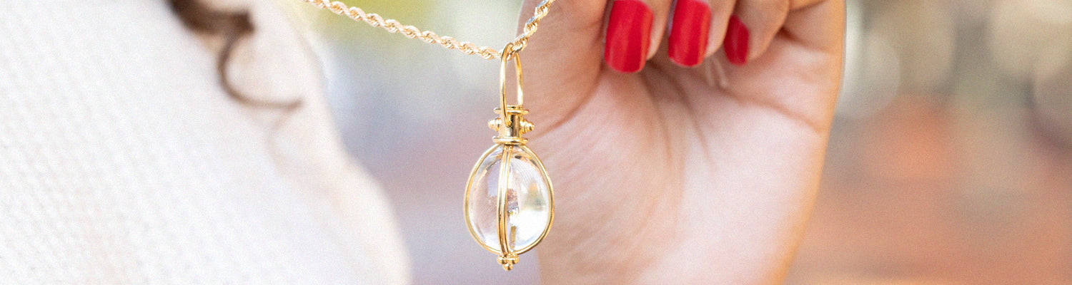 Woman Wearing a Gold Teardrop Pendant